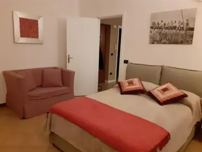 a bedroom with a bed and a chair at Palazzo Edy&Stef 1 in Palermo
