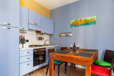 a kitchen with a wooden table and a dining room at Palazzo Edy&Stef 1 in Palermo