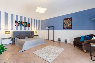 a living room with a bed and a couch at Palazzo Edy&Stef 1 in Palermo