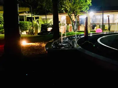 a water fountain in a park at night at Hotel Oasi da Paolo in Castelluzzo