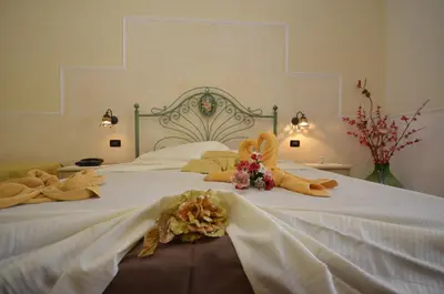 a bedroom with two beds with stuffed animals on them at Hotel Oasi da Paolo in Castelluzzo