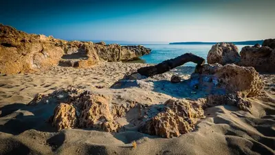 a group of rocks on a beach near the water at Hotel Oasi da Paolo in Castelluzzo