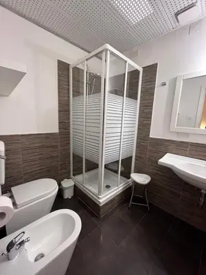 a bathroom with a shower and a toilet and a sink at Giulio Cesare 14, Residence in Palermo