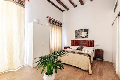 a bedroom with a large bed and a large window at Giulio Cesare 14, Residence in Palermo