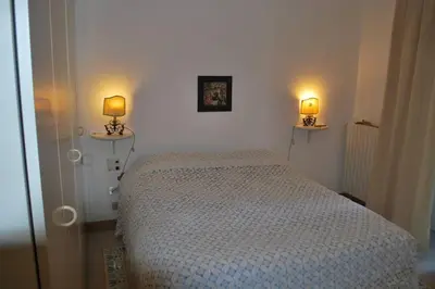 a bedroom with a bed and two lamps on the wall at casa immersa nel verde al centro di Palermo in Palermo