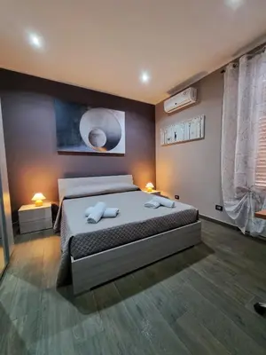a bedroom with a bed with two towels on it at B&B Rampante in Piana degli Albanesi