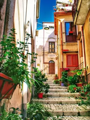 an alley with stone stairs in an old town at B&B Rampante in Piana degli Albanesi