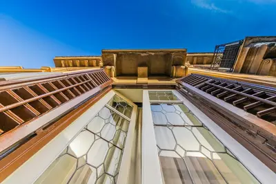 a view of the top of a building with stained glass windows at Palazzo Ardizzone in Palermo