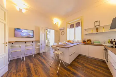 a kitchen with a table and chairs in a room at Palazzo Ardizzone in Palermo