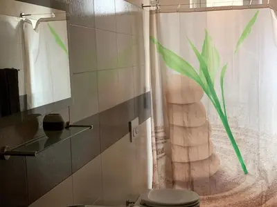 a bathroom with a toilet and a shower curtain at Casa Casteldaccia 2 in Casteldaccia
