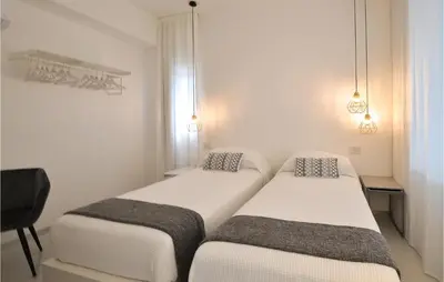 two beds in a room with white walls at Stunning Home In Balestrate in Balestrate