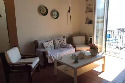 a living room with a couch and a table at Casa nel borgo marinaro di Santa Nicolicchia in Santa Flavia