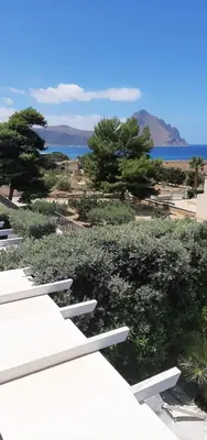 a view of trees and the ocean from a building at stella di ponente in Macari