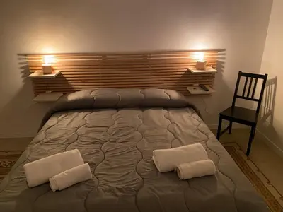 a bedroom with a large bed with two pillows at Piazza Florio Rooms in Palermo