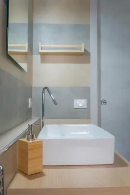 a bathroom with a white sink and a mirror at Piazza Florio Rooms in Palermo