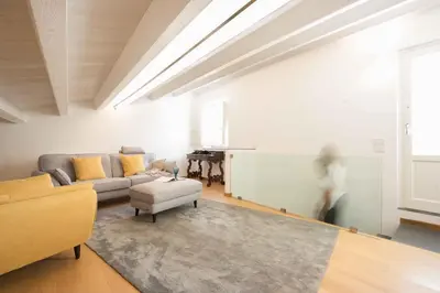 a living room with a couch and a table at Magione Apartment with Terrace by Wonderful Italy in Palermo