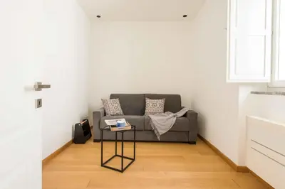 a living room with a couch and a table at Magione Apartment with Terrace by Wonderful Italy in Palermo