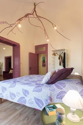 a bedroom with a bed with a blue comforter at Large apartment near Politeama 2 bathrooms Up to 8 Guests in Palermo