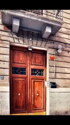 a wooden door on the side of a building at Charmie flat in Palermo