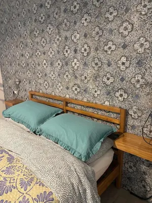 a bed with two pillows on it in a bedroom at Dost in Palermo