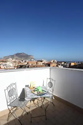 a table and chairs on a balcony with a view at Alfredo Apartment a casa di alfredo in Palermo