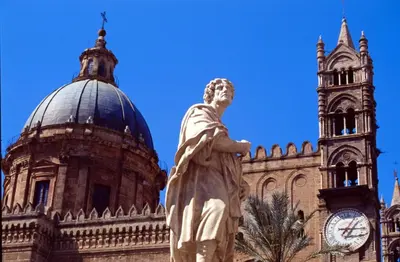 a statue in front of a building with a clock tower at Alfredo Apartment a casa di alfredo in Palermo