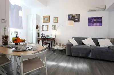 a living room with a couch and a table at Alfredo Apartment a casa di alfredo in Palermo