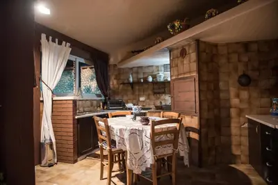 a kitchen with a table and chairs in a room at Villa Blondie con piscina a Castellammare del Golfo in Castellammare del Golfo