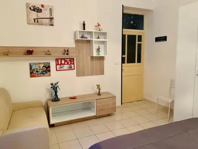 a living room with a couch and a table at Monfenera Apartment 2 in Palermo