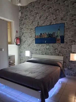 a bedroom with a bed with a tv on the wall at Monfenera Apartment 2 in Palermo