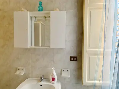 a bathroom with a sink and a mirror at Monfenera Apartment 2 in Palermo
