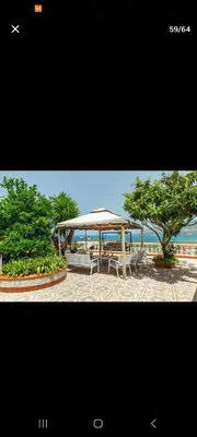 a pavilion with a table and chairs and a tree at Villa Teresa in Trappeto