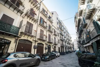 a city street with cars parked next to buildings at Casa Linda in Palermo