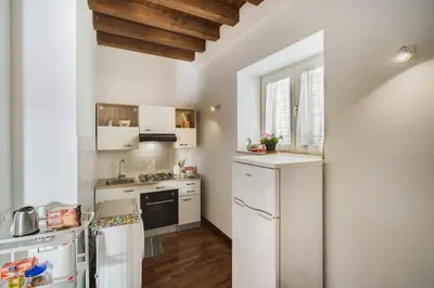 a kitchen with white appliances and a wooden ceiling at Casa Linda in Palermo
