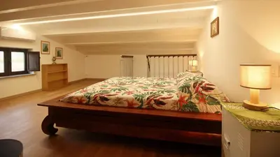 a bedroom with a bed and a lamp on a table at casa tre noci in Lascari