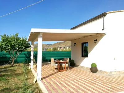 a pavilion with a table and chairs on a patio at casa tre noci in Lascari
