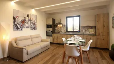 a living room with a couch and a table at casa tre noci in Lascari