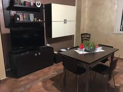 a dining room with a table and a television at Casa Igiea in Palermo