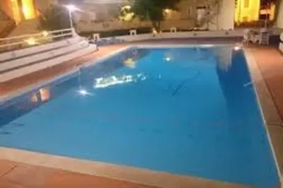 a large swimming pool with blue water at Guisomar in Palermo