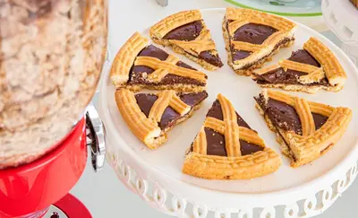 a white cake with chocolate waffles and a pie at L' Arcobaleno B&B in Castelluzzo