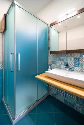 a bathroom with a glass shower and a sink at Perla di Mare Appartamenti in Castelluzzo