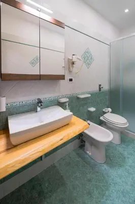 a bathroom with a sink and a toilet at Perla di Mare Appartamenti in Castelluzzo