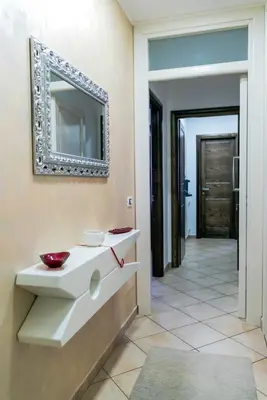 a bathroom with a sink and a mirror on the wall at Perla di Mare Appartamenti in Castelluzzo