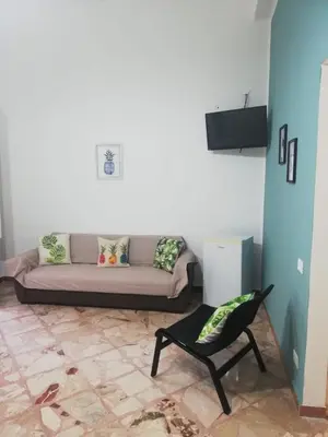 a living room with a couch and a chair at NONNA MARIA Apt 1 or Apt 2 in Terrasini
