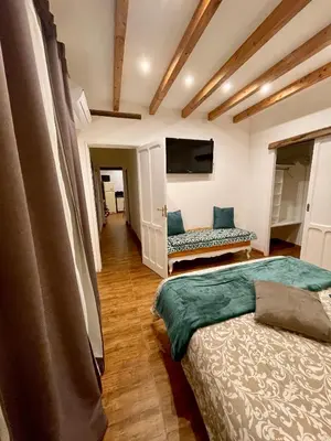 a bedroom with two beds and a flat screen tv at Interno12 in Palermo