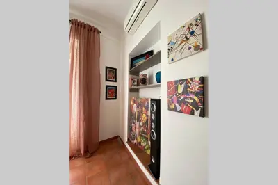 a room with some paintings on the wall at Casa Vacanze Antico Cassaro in Palermo