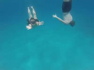 two people laying in the water in a pool at Casa Vacanze Antico Cassaro in Palermo