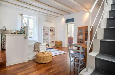 a living room with a staircase and a table at Terrazza al Capo by Wonderful Italy in Palermo
