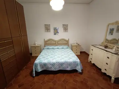 a bedroom with a bed and a dresser and a mirror at La Casetta di Nonna Anna in Palermo