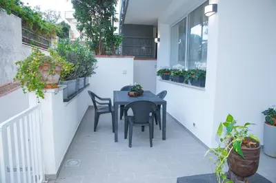 a black table and chairs on a patio with plants at MONDELLO MANICK MARE in Palermo